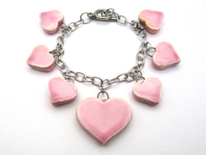 A Pink Handcrafted Ceramic Heart Dangle Charm Bracelet. Connected in a circle. A pink handcrafted ceramic heart dangle charm bracelet. Connected in a circle. A Pink Handcrafted Ceramic Heart Dangle Charm Bracelet. Connected in a circle. A pink handcrafted ceramic heart dangle charm bracelet. Connected in a circle.