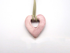 A Ceramic Open Heart Pendant Necklace Handmade from fired clay. With a beige corded necklace. A ceramic open heart pendant necklace handmade from fired clay. With a beige cord necklace. A Ceramic Open Heart Pendant Necklace Handmade from fired clay. With a beige corded necklace. A ceramic open heart pendant necklace handmade from fired clay. With a beige cord necklace.