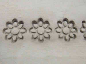 A clay imprint of an 8 Petal Flower border clay pottery stamp. A clay imprint of an 8 Petal flower border clay pottery stamp. A clay imprint of an 8 Petal Flower border clay pottery stamp. A clay imprint of an 8 Petal flower border clay pottery stamp.