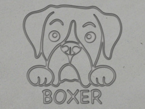 A clay imprint of a Boxer mug clay pottery stamp. With a Boxer head with paws on top of the word Boxer. A clay imprint of a Boxer mug clay pottery stamp. With a Boxer head with paws on top of the word Boxer.