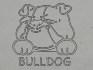 A clay imprint of a Bulldog clay pottery stamp. With a Bulldog head on top of the word Bulldog.