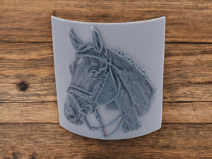 A horse head closeup clay pottery stamp. Very detailed image of a horse head with riding straps across head & around neck. A horse head closeup clay pottery stamp. Very detailed image of a horse head with riding straps across head & around neck.