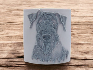 Airedale dog head close up, clay pottery stamp for potters to add texture image to ceramics, On a wood look background. Airedale dog head close up, clay pottery stamp for potters to add texture image to ceramics, On a wood look background.