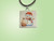 ceramic pendant pottery necklace showing snowman with oversized cupcake