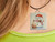 handcrafted pottery necklace showing snowman with large cupcake