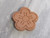 A finished brown terracotta clay sugar saver- small flower bloom. On a gray marble look background. A finished brown terracotta clay sugar saver- small flower bloom. On a gray marble look background.