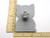 A cute cat shaped pottery stamp with cutter. Next to ruler. Measuring approximately 2 inches by 3 inches.