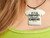 A handmade ceramic Tshirt pendant with the words "If Only Sarcasm Burned calories". On a black cord necklace. Shown on a woman's neck.