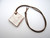 An aromatherapy terracotta diamond shaped white lace ceramic handmade necklace. On a brown cord necklace. An aromatherapy terracotta diamond shaped white lace ceramic handmade necklace. On a brown cord necklace.