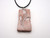 A leaves and stems (Design 1) ceramic Rectangle Terracotta pendant necklace. On a black cord necklace.