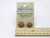 A set of small flower aromatherapy terracotta post earrings. On an A Mayes Pottery card.   With a ruler. A set of small flower aromatherapy terracotta post earrings. On an A Mayes Pottery card.   With a ruler.