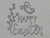 A clay imprint of "Happy Easter" with stems with leaves and a butterfly mug clay stamp for handbuild pottery.