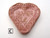 A handcrafted heart shaped trinket bowl. The main color is dark pink with dark red flower raised imprints on the dish. A handcrafted heart shaped trinket bowl. The main color is dark pink with dark red flower raised imprints on the dish.