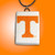 A TN Vols Power T rectangle handcrafted ceramic pendant. Pendant has a white background with the Orange Power T in the middle. With a black cord necklace. On an orange background.