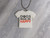 A marble look background. With A  Handmade Ceramic Tshirt Necklace saying "Dogs Make Me Happy". On a black corded necklace. A marble look background. With a handmade ceramic Tshirt necklace saying "Dogs Make Me Happy". On a black cord necklace. A marble look background. With A  Handmade Ceramic Tshirt Necklace saying "Dogs Make Me Happy". On a black corded necklace. A marble look background. With a handmade ceramic Tshirt necklace saying "Dogs Make Me Happy". On a black cord necklace.