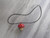 A Ceramic red top Mushroom handcrafted necklace handmade jewelry . On a black corded necklace. A ceramic red top mushroom handcrafted necklace handmade jewelry. A Ceramic red top Mushroom handcrafted necklace handmade jewelry . On a black corded necklace. A ceramic red top mushroom handcrafted necklace handmade jewelry.