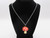 A Ceramic red top Mushroom handcrafted necklace handmade jewelry. On a black corded necklace. Displayed on bust. A ceramic red top mushroom handcrafted necklace handmade jewelry. On a black cord necklace. Displayed on bust. A Ceramic red top Mushroom handcrafted necklace handmade jewelry. On a black corded necklace. Displayed on bust. A ceramic red top mushroom handcrafted necklace handmade jewelry. On a black cord necklace. Displayed on bust.