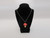 A Ceramic red top Mushroom handcrafted necklace handmade jewelry. On a black corded necklace. Displayed on bust. A Ceramic red top Mushroom handcrafted necklace handmade jewelry. On a black corded necklace. Displayed on bust.