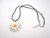 A Large Daisy Handmade Ceramic Pendant Necklace. With black corded necklace. A large daisy handmade ceramic pendant necklace. With black cord necklace. A Large Daisy Handmade Ceramic Pendant Necklace. With black corded necklace. A large daisy handmade ceramic pendant necklace. With black cord necklace.
