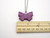A Purple Ceramic Butterfly Pendant Necklace Handmade from fired earthenware clay. On a silver colored chain necklace. With ruler. Measuring approximately 1.25 inches long. A purple ceramic butterfly pendant necklace handmade from fired earthenware clay. On a silver colored chain necklace. A Purple Ceramic Butterfly Pendant Necklace Handmade from fired earthenware clay. On a silver colored chain necklace. With ruler. Measuring approximately 1.25 inches long. A purple ceramic butterfly pendant necklace handmade from fired earthenware clay. On a silver colored chain necklace.