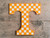 Checkered Power T on wooden wall