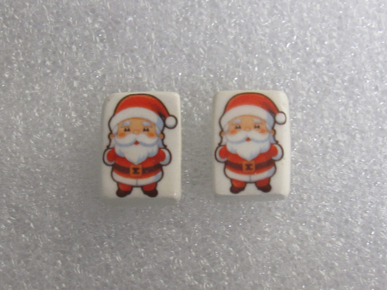 A set of handmade ceramic Christmas Santa clay stud earrings. A set of handmade ceramic Christmas Santa clay stud earrings.