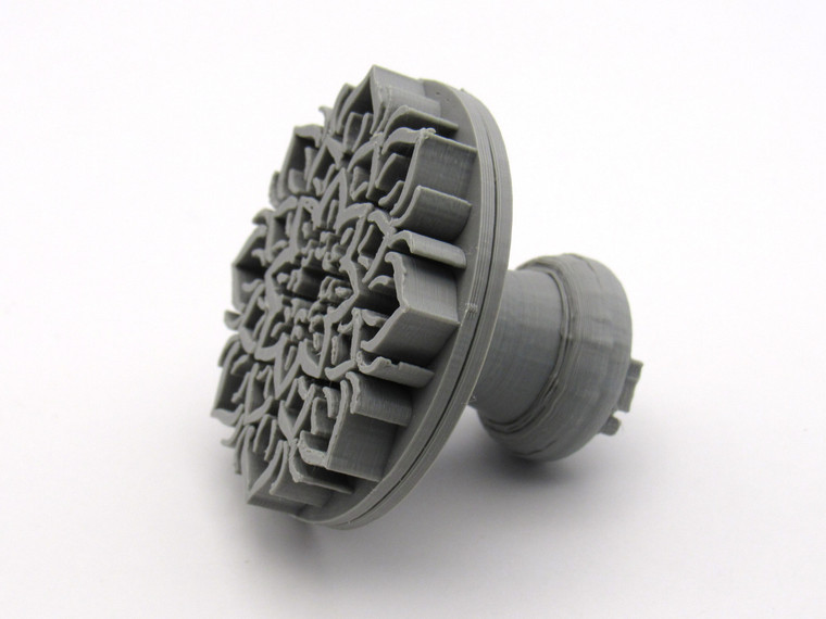 The side angle of A mandala accent (Design 2) clay pottery texture stamp.