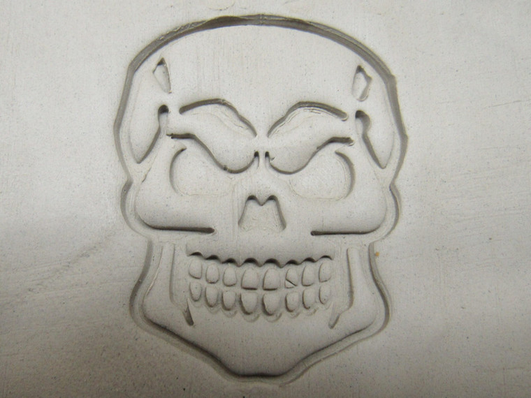 A clay imprint of A Skull Mug Clay Stamp for Handbuild Pottery.