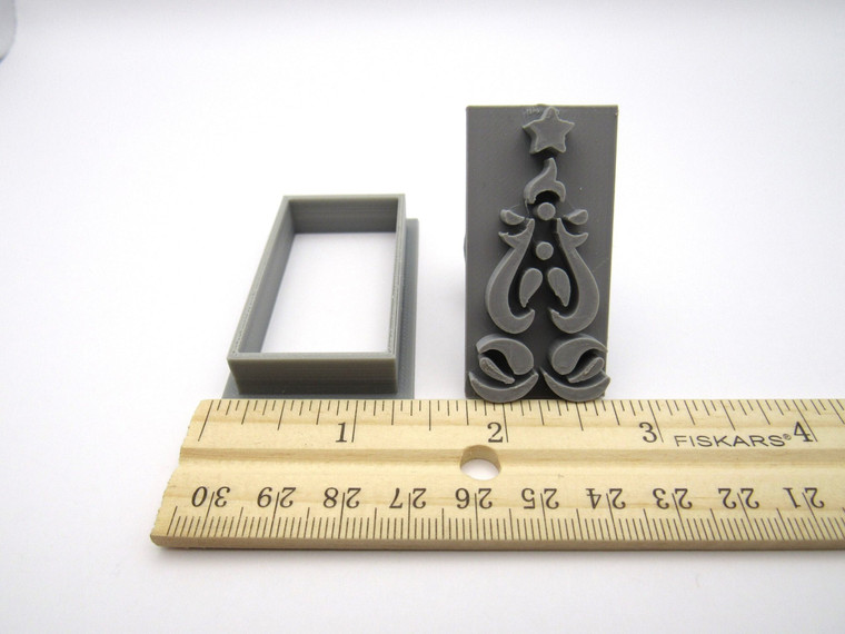 An abstract tree clay pottery stamp and cutter. With ruler. Measuring approximately 1 inch wide.