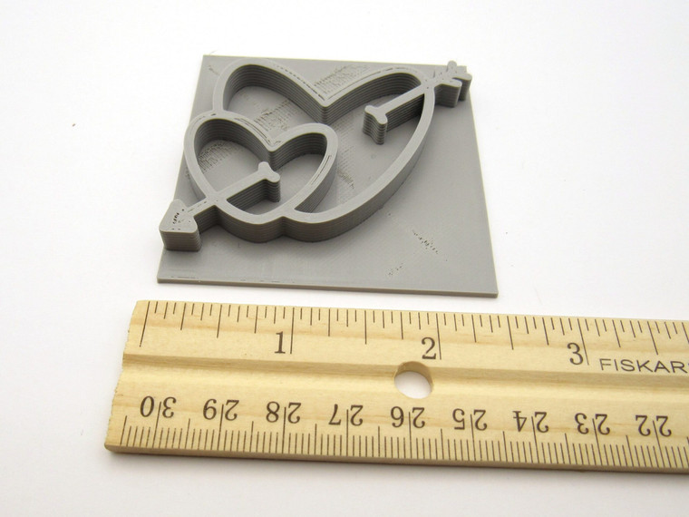 A double hearts with arrow clay pottery stamp for handbuild slab pottery. Shown with ruler. Measuring 2.5 inches wide. A double hearts with arrow clay pottery stamp for handbuild slab pottery. Shown with ruler. Measuring 2.5 inches wide.