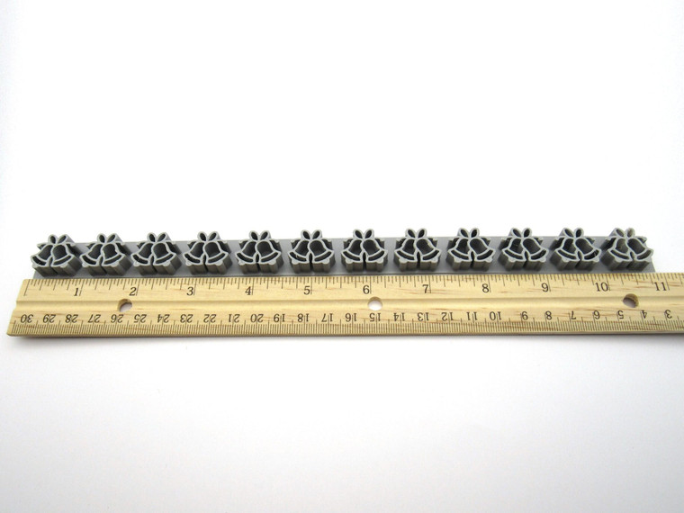 A Christmas Bells border clay stamp for handbuild pottery. With ruler. Showing 11 inches in length. A Christmas Bells border clay stamp for handbuild pottery. With ruler. Showing 11 inches in length.