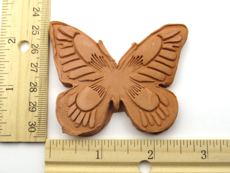 A Brown Sugar Saver Butterfly Terracotta Clay Handcrafted in USA. With ruler. Showing 2.5 in wide & 2.5 inches in length.