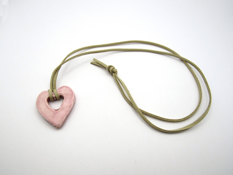 A Ceramic Open Heart Pendant Necklace Handmade from fired clay. With a beige corded necklace. A ceramic open heart pendant necklace handmade from fired clay. With a beige cord necklace.