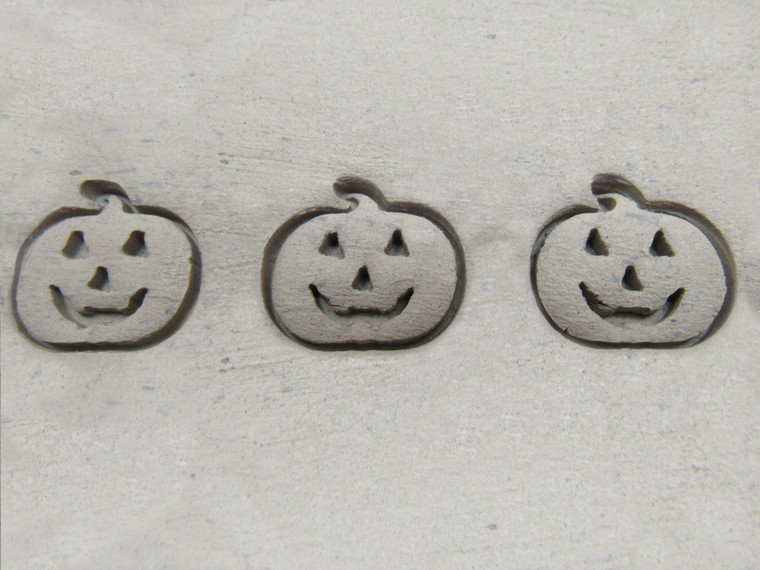 A clay imprint of a Smiling Pumpkin Halloween Border Clay slab pottery stamp. A clay imprint of a smiling pumpkin Halloween border clay stamp.