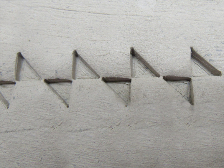 A clay imprint of a Angled Bowties border stamp for handbuild pottery. A clay imprint of an angled bowties border stamp for handbuild pottery.