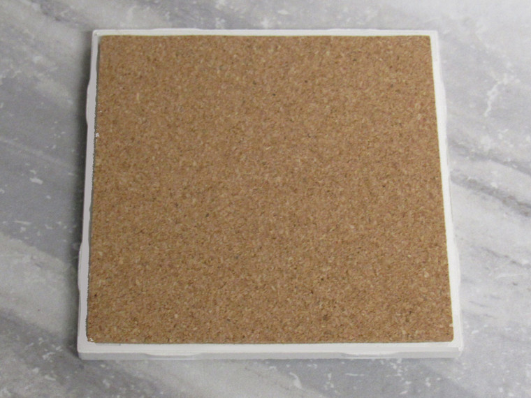 The Back view of a Deer Trivet Ceramic Coaster Holiday Buck Deer with poinsettias, pine cones, berries and leaves square Hot Pad. Showing the cork side.