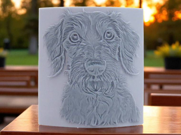 Wire Haired Dachshund dog close up, clay pottery stamp for potters to add texture image to ceramics, On a wood table with a sunny background.