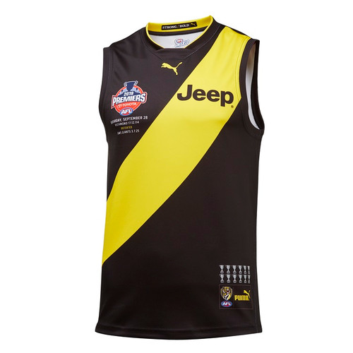 Black Guernsey with yellow sash AFL Premiership, jeep and PUMA logo. The back has a cup with the players names, coaches name, date and score.