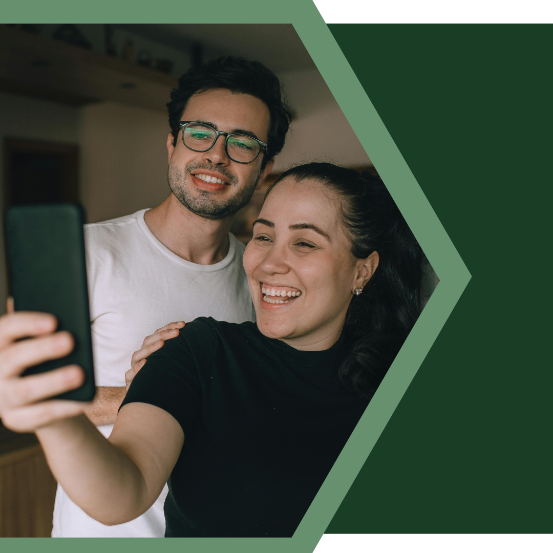 smiling couple looking at phone