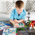 Little boy studying the STEM kit with his microscope next to him.