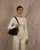 Kota K Shoulder Bag N/S in Black taurillon leather, worn on the shoulder