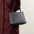 KOTA Joni bag in flint taurillon leather worn in crook of arm