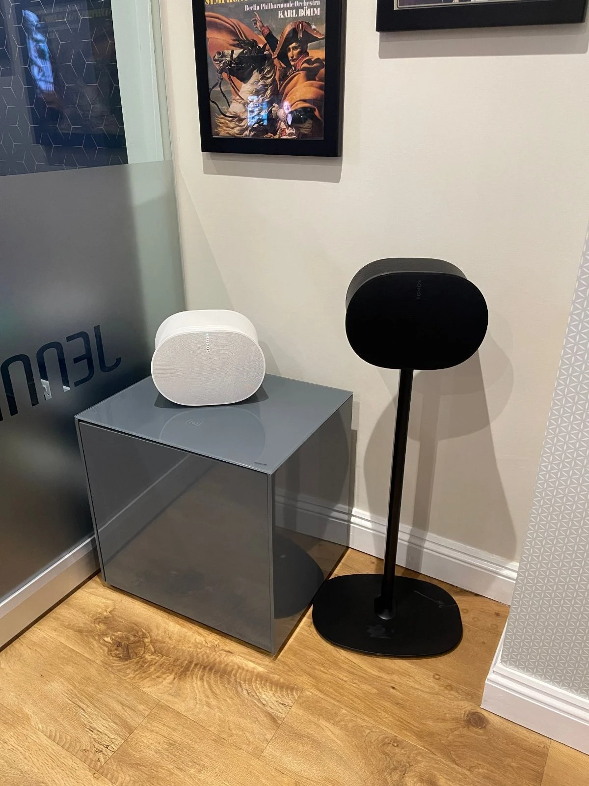 A white Sonos Era 300 on a display plinth and a black Era 300 on a floor stand in the Jennings showroom, Fleet