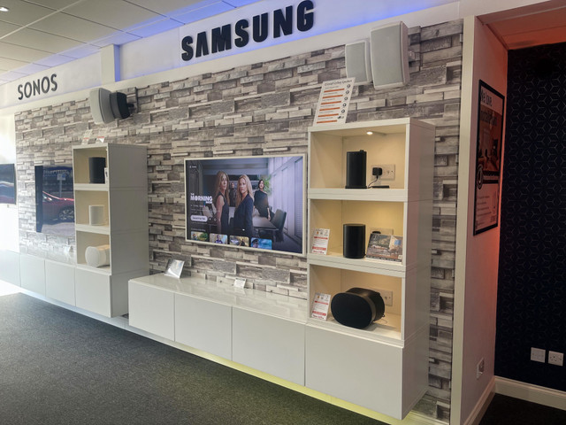 Wall-mounted TV with Sonos speakers in the Jennings showroom, Fleet