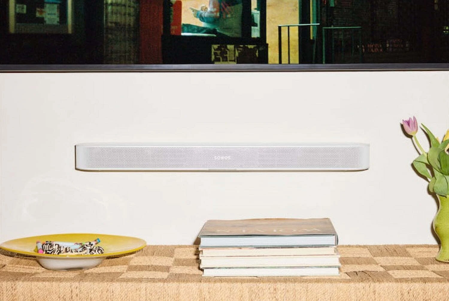 Sonos Beam Ultra soundbar in White mounted under a TV, slim low-profile design