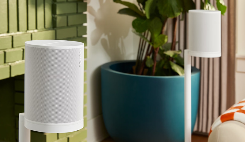 Sonos ERA 100 SL in white shown on stands in a living room