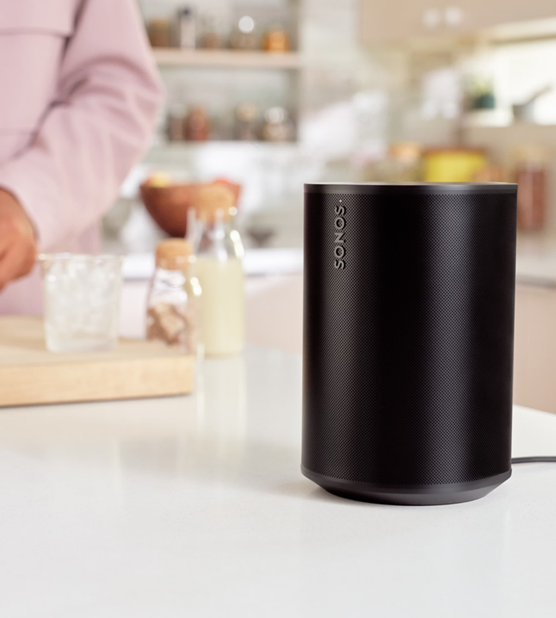 Sonos ERA 100 smart speaker shown on a kitchen worktop