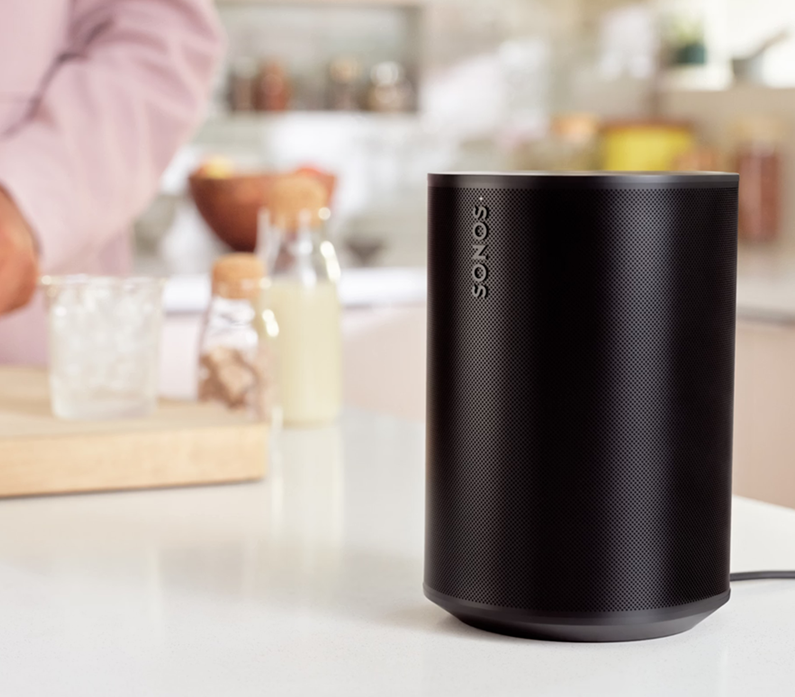 Sonos ERA 100 smart speaker shown on a kitchen worktop