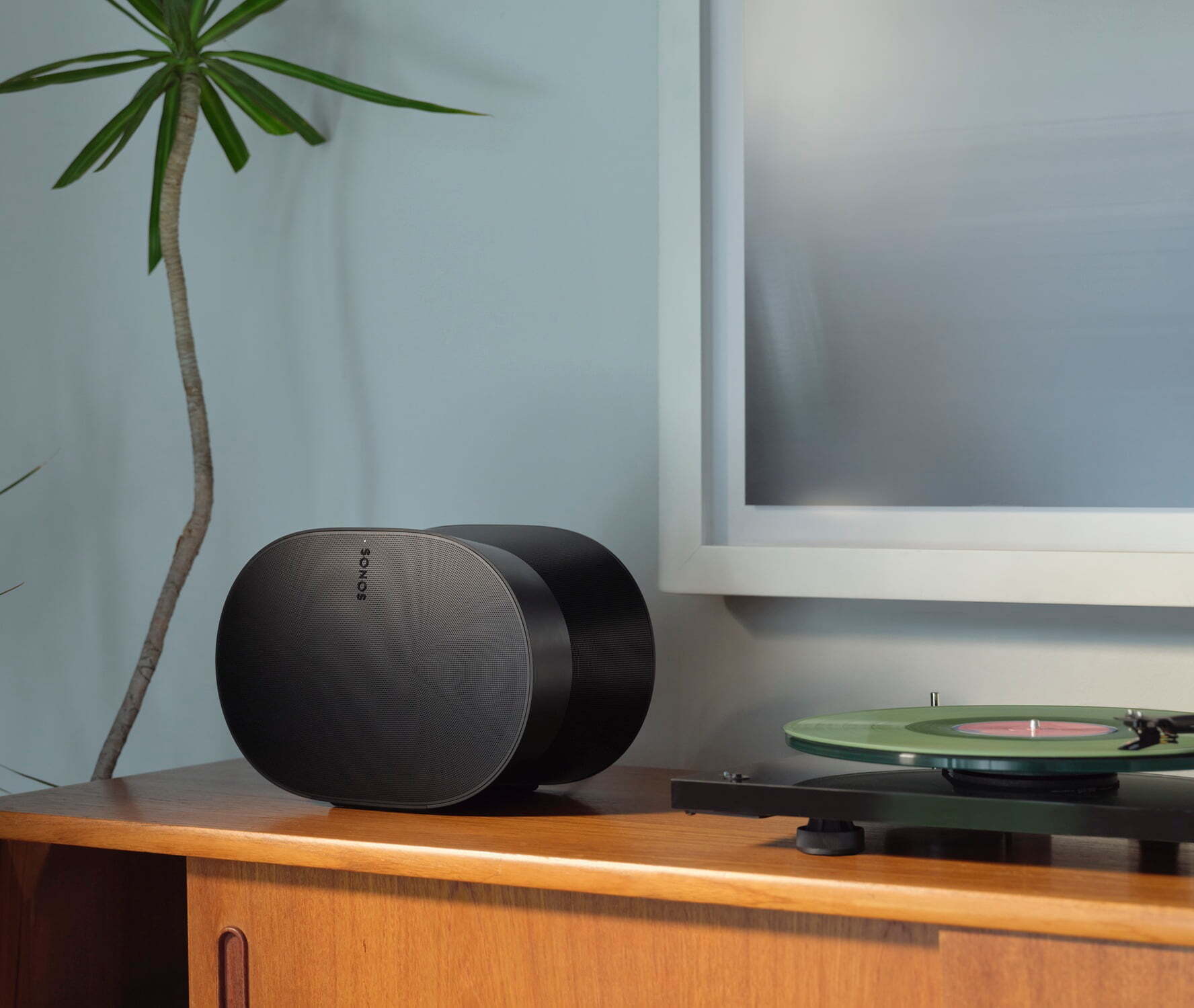 Sonos Era 300 speaker on wooden sideboard next to turntable in living room