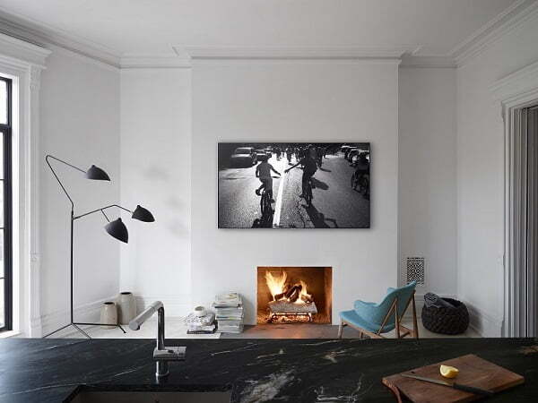 Wall-mounted TV above a fireplace in a modern living room